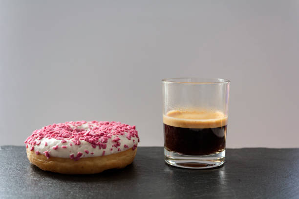 Glazes Donut and a cup of black coffee