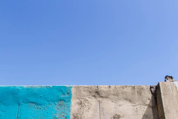 istock The old concrete block wall on gradient of blue sky 1073792982