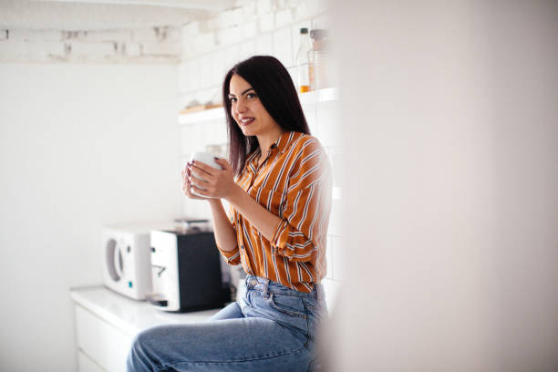 istock Thoughtful woman holding coffee mug 1073793954