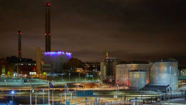 istock Modern grain terminal at night. Metal tanks of elevator. Grain-drying complex construction. Commercial grain or seed silos at seaport. Steel storage for agricultural harvest 1073794566