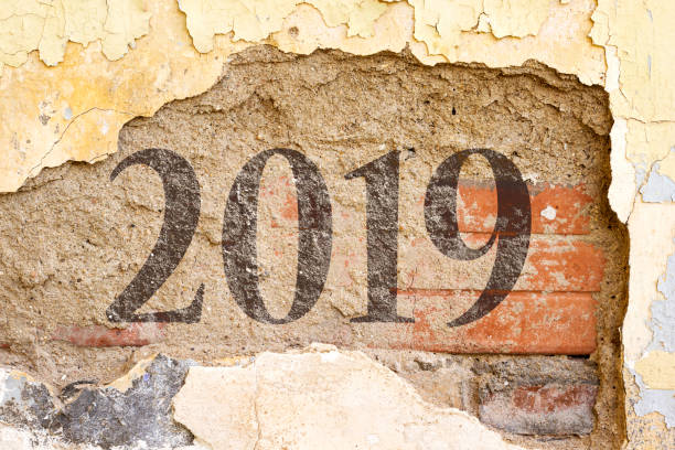 istock 2019 new year painted on  Old Brick Wall Texture. Painted Distressed Wall Surface. Grungy Wide Brick wall. Grunge Red Stonewall Background. Shabby Building Facade With Damaged Plaster. 1073796744