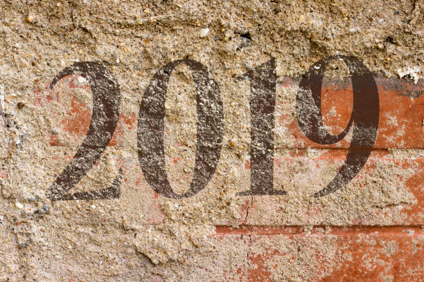 istock 2019 new year painted on  Old Brick Wall Texture. Painted Distressed Wall Surface. Grungy Wide Brick wall. Grunge Red Stonewall Background. Shabby Building Facade With Damaged Plaster. 1073798704