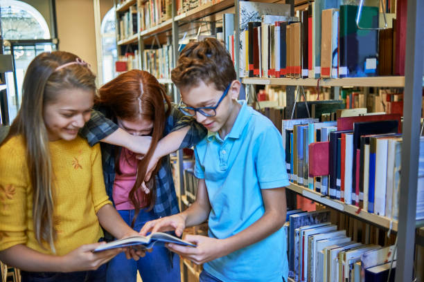 istock school friends doing some research together in the library 1073803840