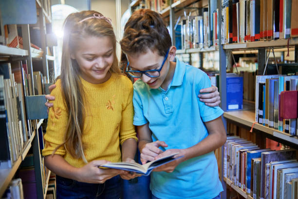 istock school friends doing some research together in the library 1073804060
