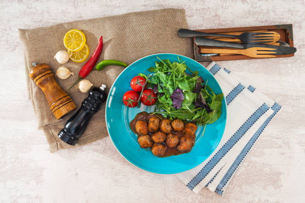 istock Meatball, bacon and potatoes with lettuce on white plat 1073806902