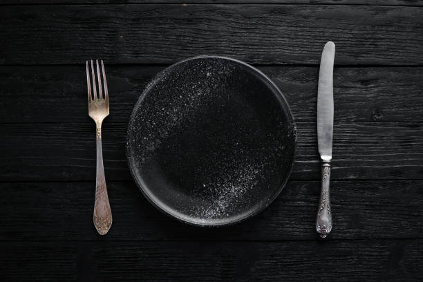 istock Clay dishes. A plate on a black background. Top view. Free copy space. 1073816282