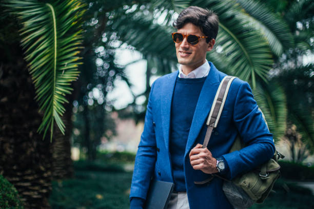 istock Guy with sunglasses walking in park 1073820814