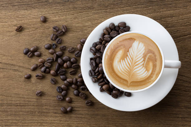 istock Latte coffee on wooden table 1073826590