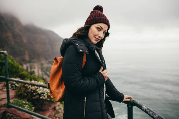 istock Female tourist standing by a mountain top railing 1073828536
