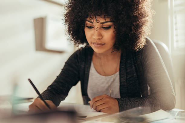 istock Female architect busy working at her desk 1073829338