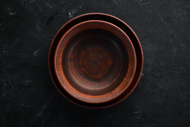 istock Clay dishes. A plate on a black background. Top view. Free copy space. 1073836020