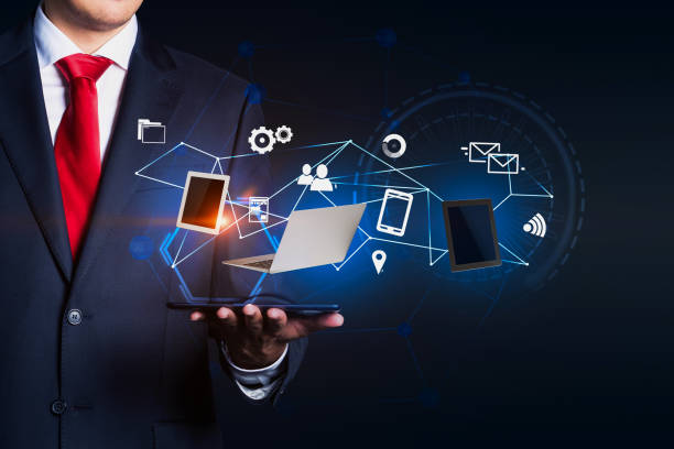 istock Man in red tie holding internet icons 1073836048