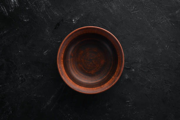 istock Clay dishes. A plate on a black background. Top view. Free copy space. 1073836062