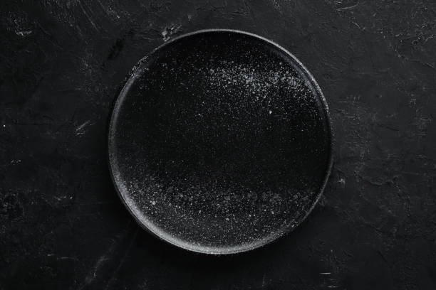 istock Clay dishes. A plate on a black background. Top view. Free copy space. 1073836230