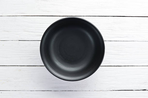 istock Clay dishes. A plate on a white wooden background. Top view. Free copy space. 1073836848