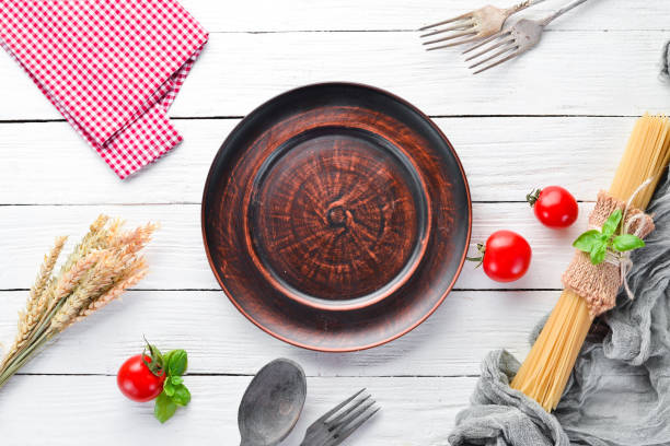 istock Clay dishes. A plate on a white wooden background. Top view. Free copy space. 1073836984