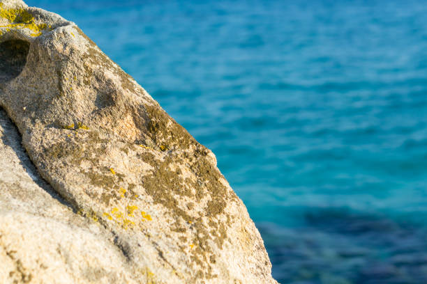 istock Stone in front of sea water on sunny day. 1073840200