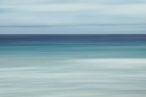 istock Empty sea and beach background with copy space, Long exposure, blur motion blue abstract vintage tinted gradient background 1073852302