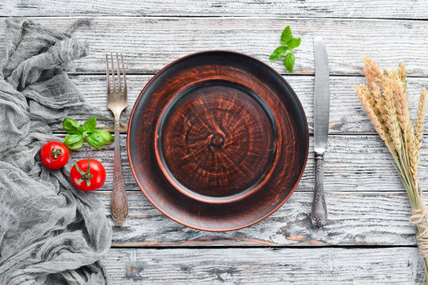 istock Clay dishes. A plate on a white wooden background. Top view. Free copy space. 1073852568