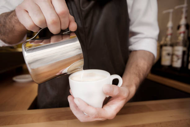 istock Young Barista making latte 1073861772