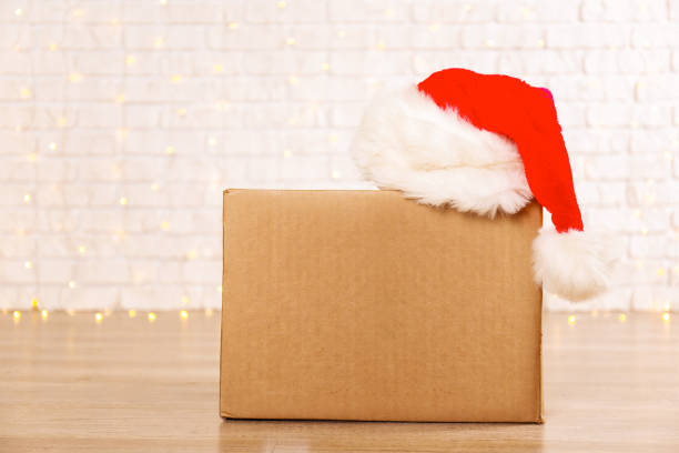 istock Corrugated fiberboard boxes with christmas lights on background. 1073866940