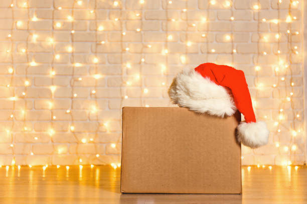 istock Corrugated fiberboard boxes with christmas lights on background. 1073866988