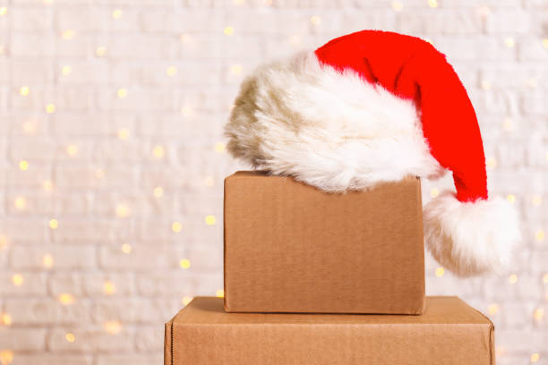 istock Corrugated fiberboard boxes with christmas lights on background. 1073867034