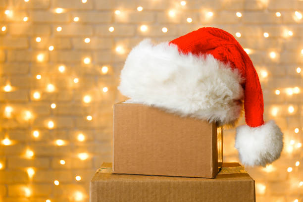 istock Corrugated fiberboard boxes with christmas lights on background. 1073867152