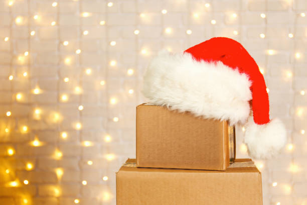 istock Corrugated fiberboard boxes with christmas lights on background. 1073867178