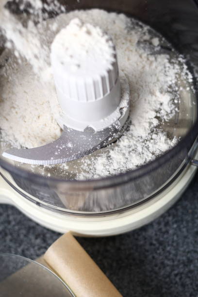 istock Pouring flour into food processor. Making Boston Banoffee Pie. 1073867272