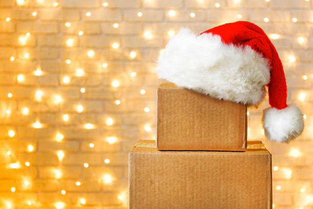 istock Corrugated fiberboard boxes with christmas lights on background. 1073867302