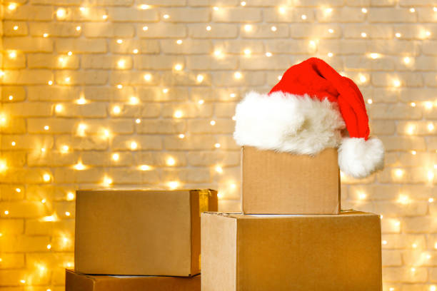 istock Corrugated fiberboard boxes with christmas lights on background. 1073867322