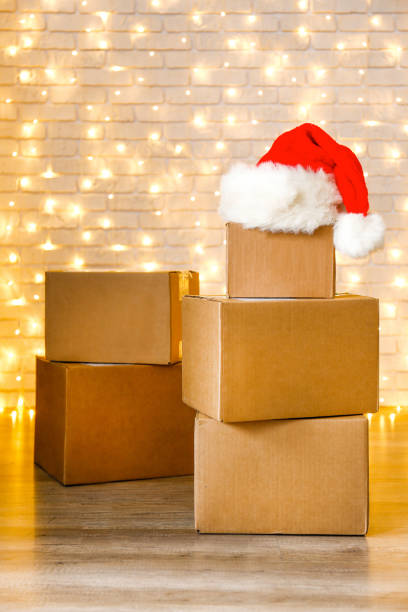 istock Corrugated fiberboard boxes with christmas lights on background. 1073867326