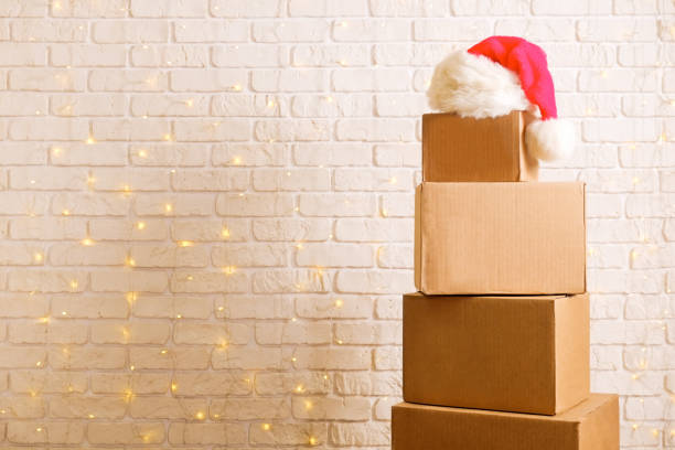 Corrugated fiberboard boxes with christmas lights on background.