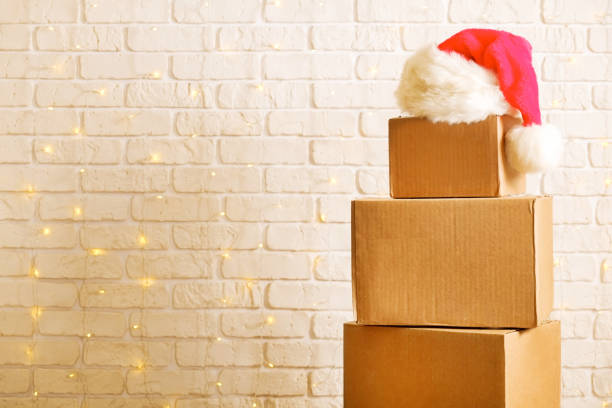 istock Corrugated fiberboard boxes with christmas lights on background. 1073867376