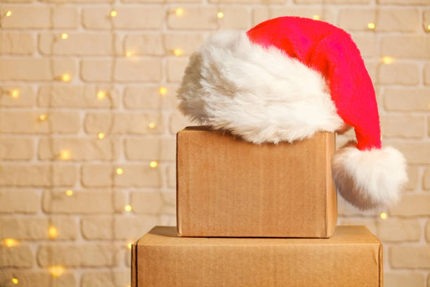 istock Corrugated fiberboard boxes with christmas lights on background. 1073867382
