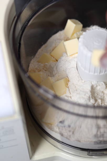 istock Adding diced butter into food processor with flour. Making Boston Banoffee Pie. 1073867438