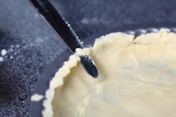 istock Trim dough edges with knife. Making Boston Banoffee Pie. 1073868218