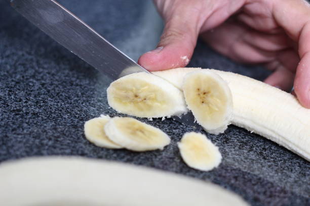 istock Slicing bananas. Making Boston Banoffee Pie. 1073872492