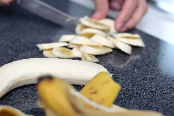 istock Slicing bananas. Making Boston Banoffee Pie. 1073872534