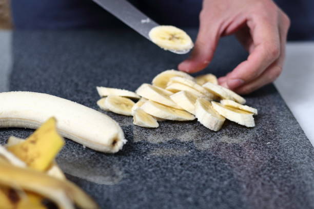 istock Slicing bananas. Making Boston Banoffee Pie. 1073872590