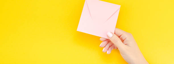 istock Woman hand with pink envelope 1073874018