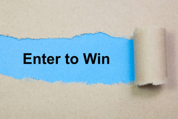 istock Enter to win text on paper. Word Enter to win on torn paper. Concept Image. 1073877518