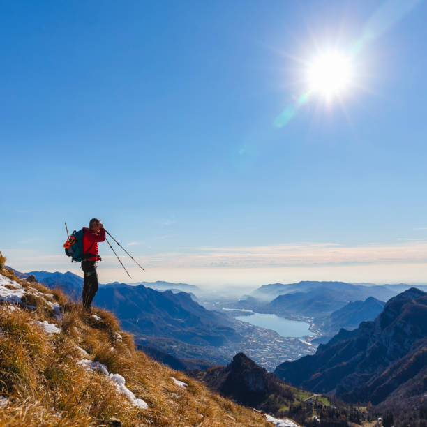 Hiker on mountain peak looking panorama valley
