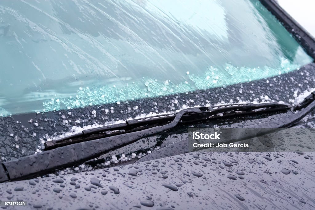 windshield wiper with rain drops and ice Windshield wipers on cold weather Rain Stock Photo