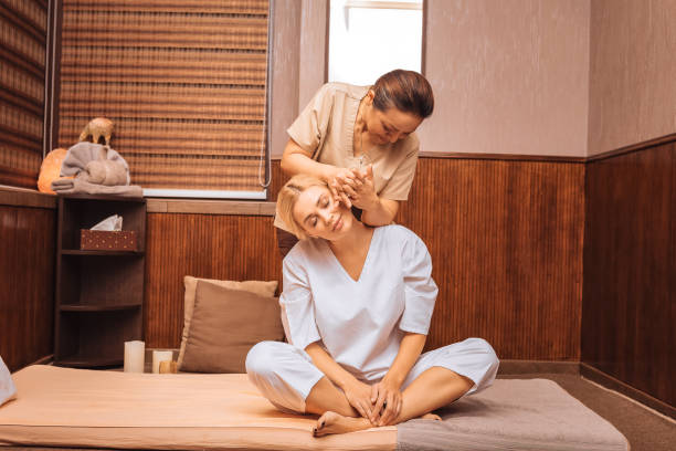 istock Delighted young woman sitting on the mat 1073882608
