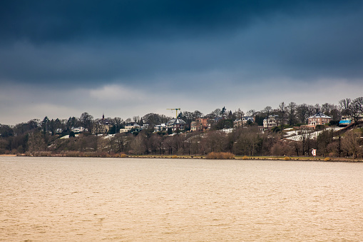 Beautiful houses and beaches on the banks of Elbe river in Hamburg on a cold end of winter day