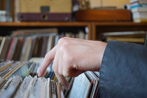 Hand looking through Records