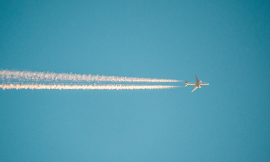 An image taken of a passenger jet at high altitude.