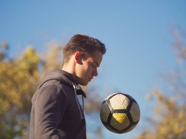 istock Soccer Player Practicing with Football 1073904618